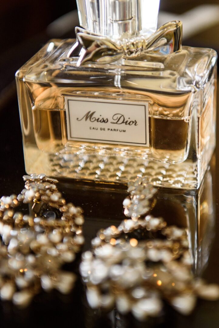 A Miss Dior perfume bottle with sparkling jewelry.